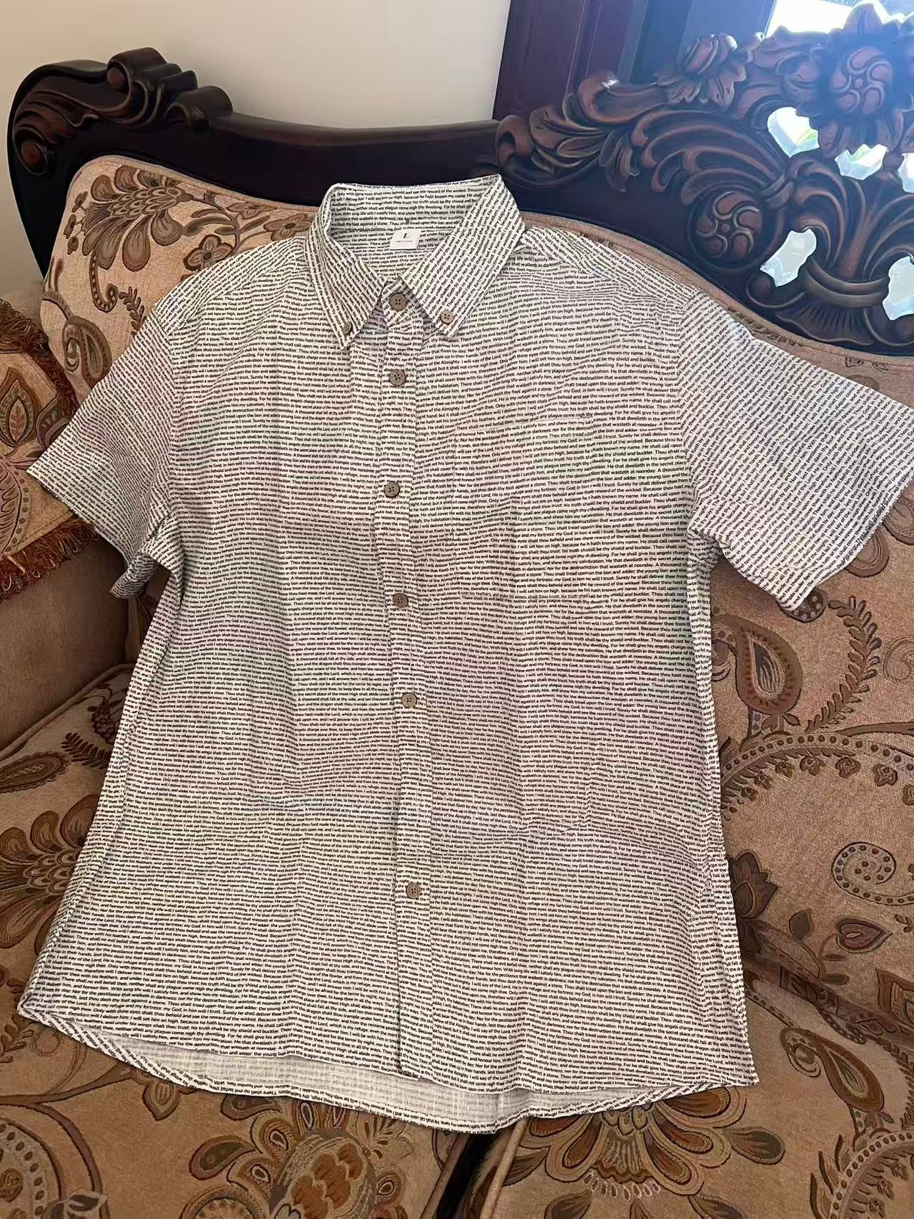 Flat lay shot of light grey custom printed short sleeve shirt, fully displaying fabric texture and pattern details