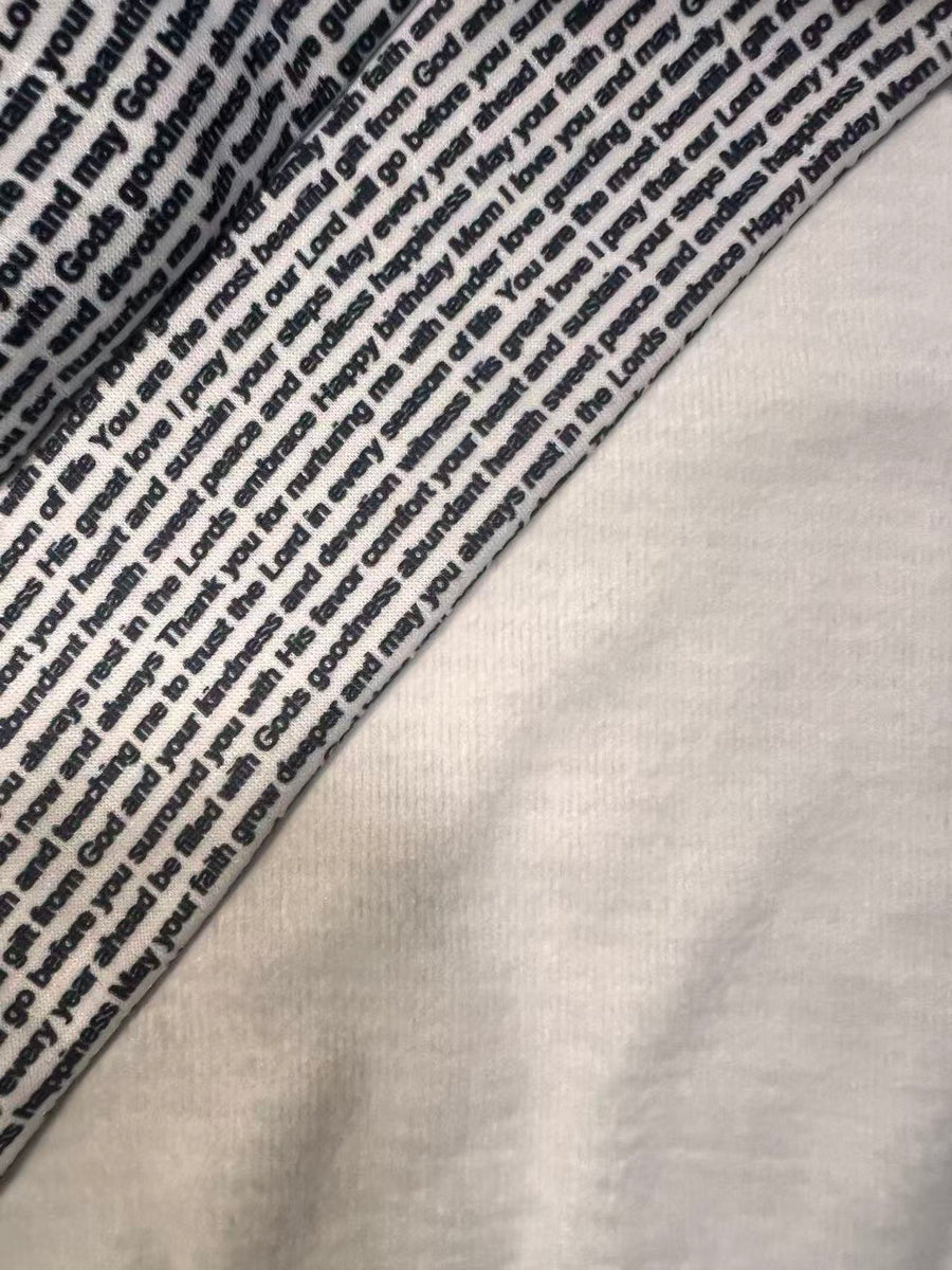 Close-up of custom printed fleece fabric showing clear text and a soft warm texture